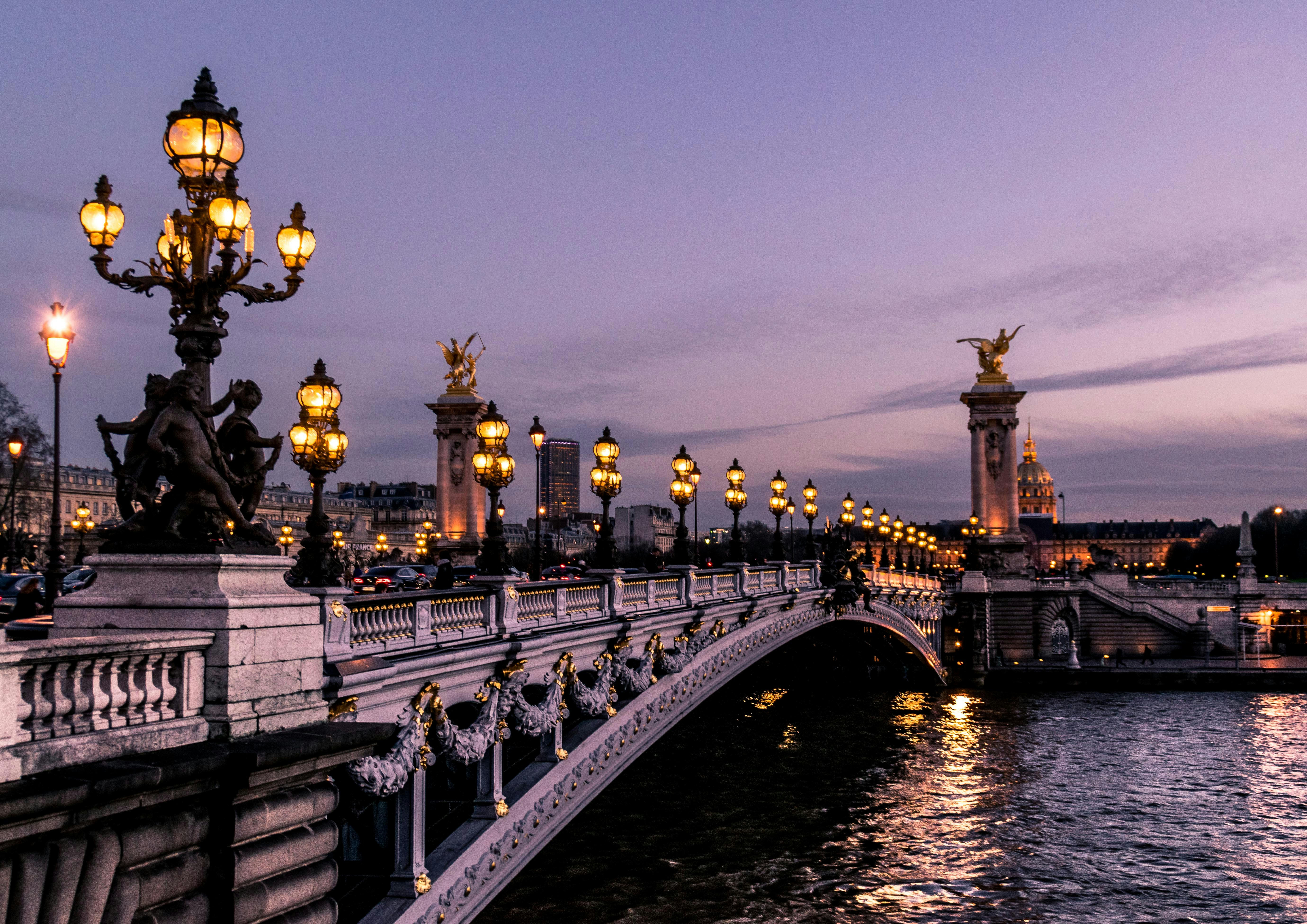 Runway models walking at Paris Fashion Week with city backdrop